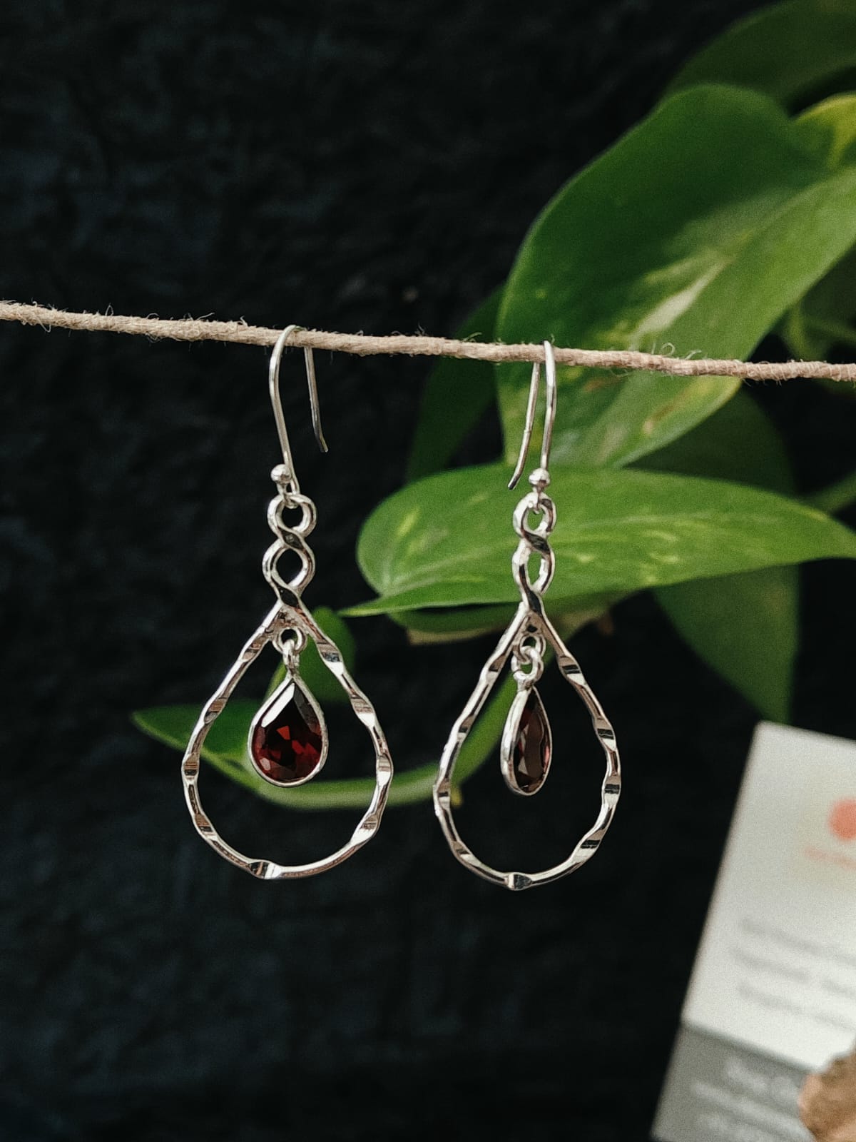 Silver teardrop earrings with red gemstones