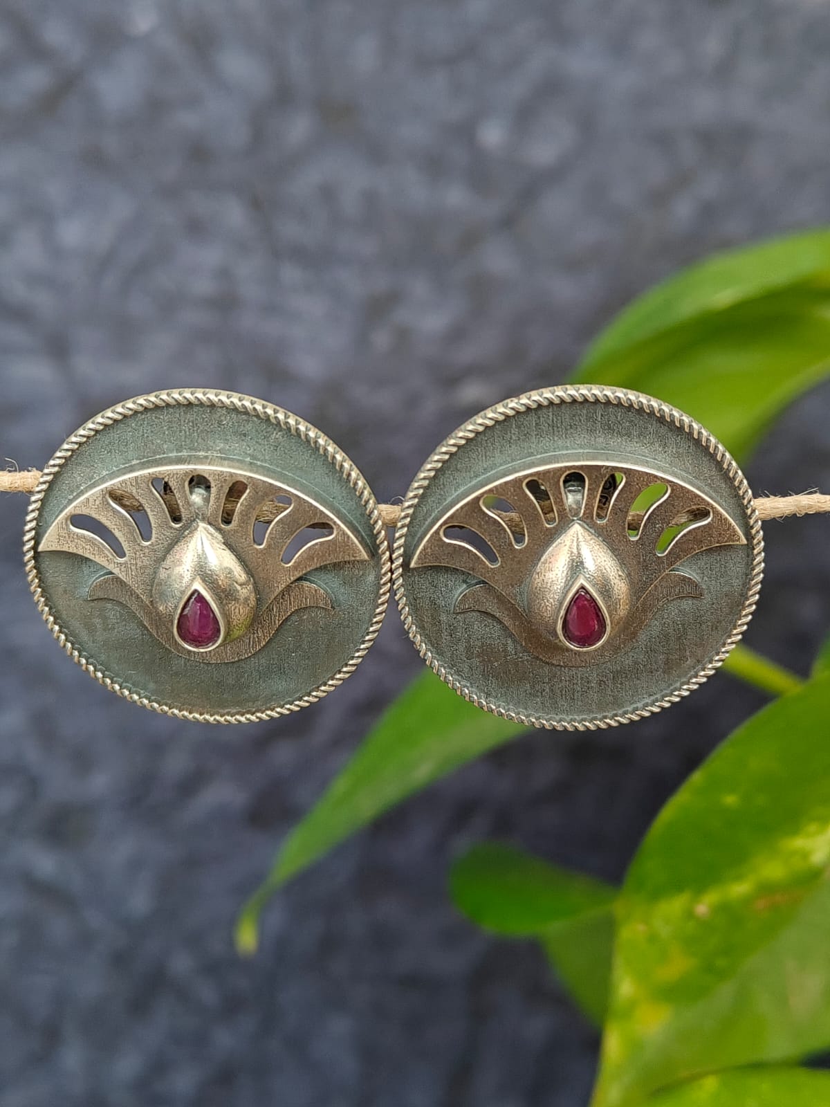 Pair of silver earrings with red gemstones