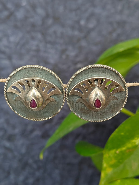 Pair of silver earrings with red gemstones