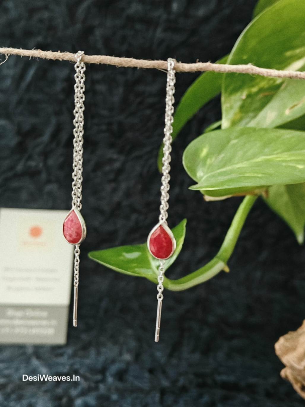 Silver earrings with red teardrop stones